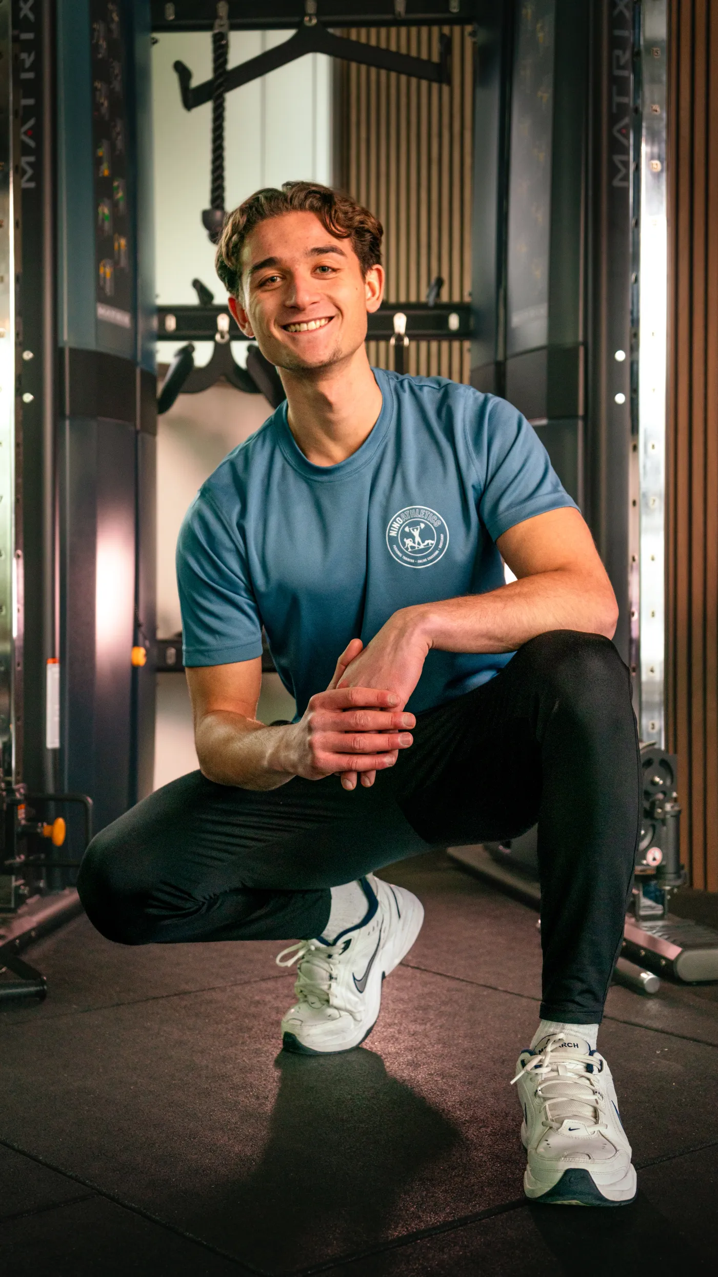 Nino Athletics personal trainer Nino smiling in gym — brand photography by 7EMPLE