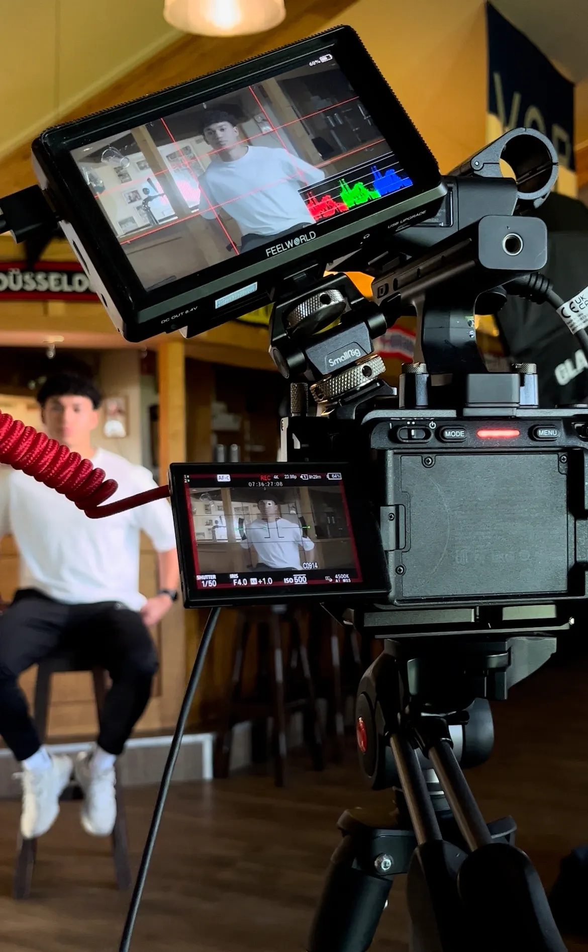 VitaQ brand film BTS — camera filming subject in café location by 7EMPLE