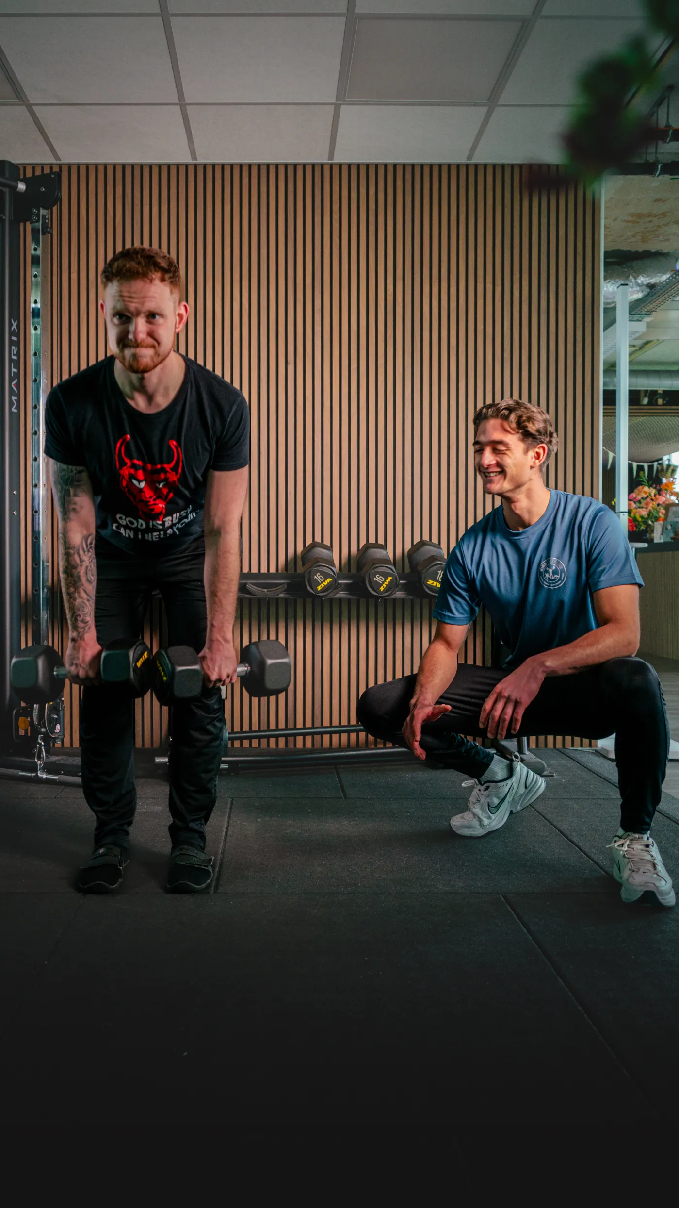 Nino personal trainer coaching client on dumbbell exercise — fitness brand photography by 7EMPLE