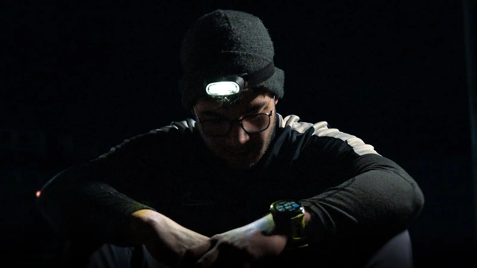 Sem Koopman checking watch during 100km ultramarathon night run — documentary by 7EMPLE